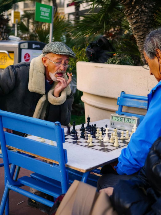 man in blue jacket sitting on blue chair